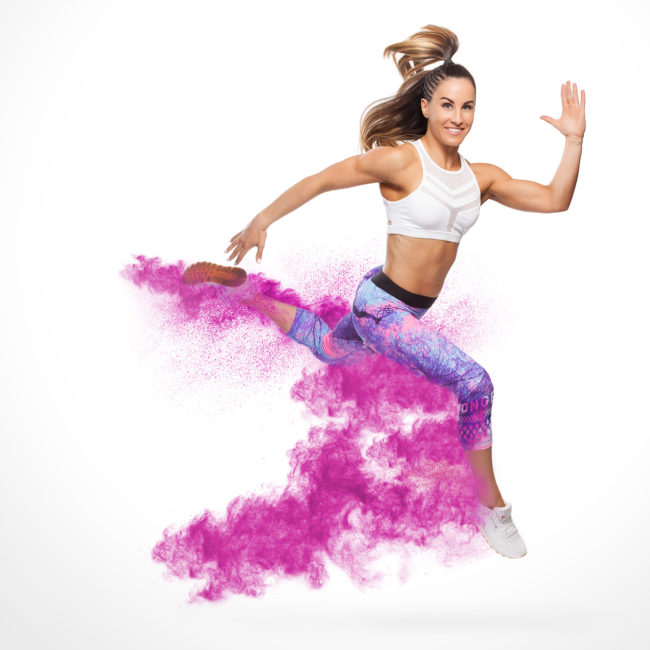 woman jumping in studio with powder