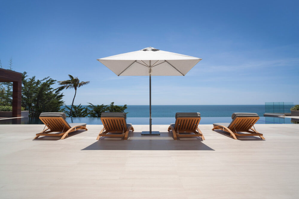 Four Summit Furniture lounge chairs with Santa Barbara Designs Umbrella poolside in Malibu