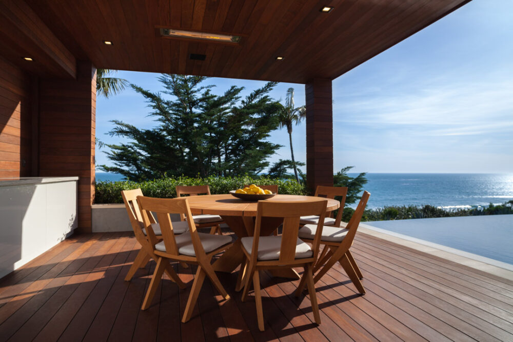 Summit Furniture chairs and table sitting poolside in Malibu near the Pacific Ocean