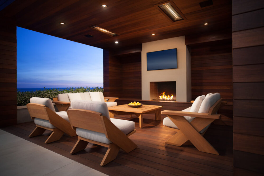 Summit Furniture chairs and sofa outdoors near fireplace at sunset in Malibu