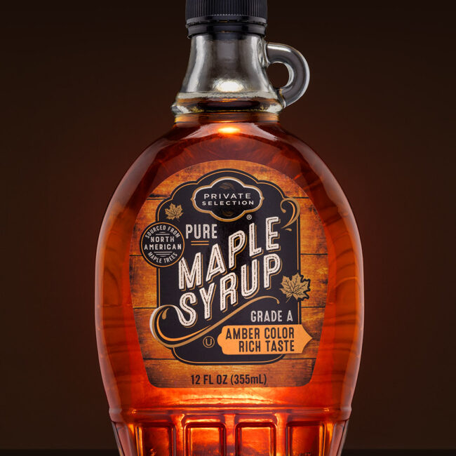 Bottle of Maple Syrup with amber color and black bottle cap