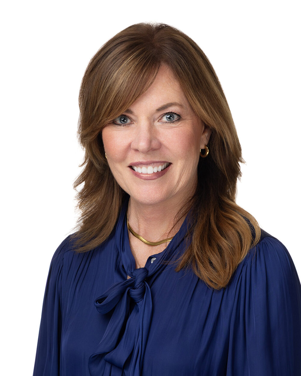 Headshot of woman in blue blouse with gold necklace
